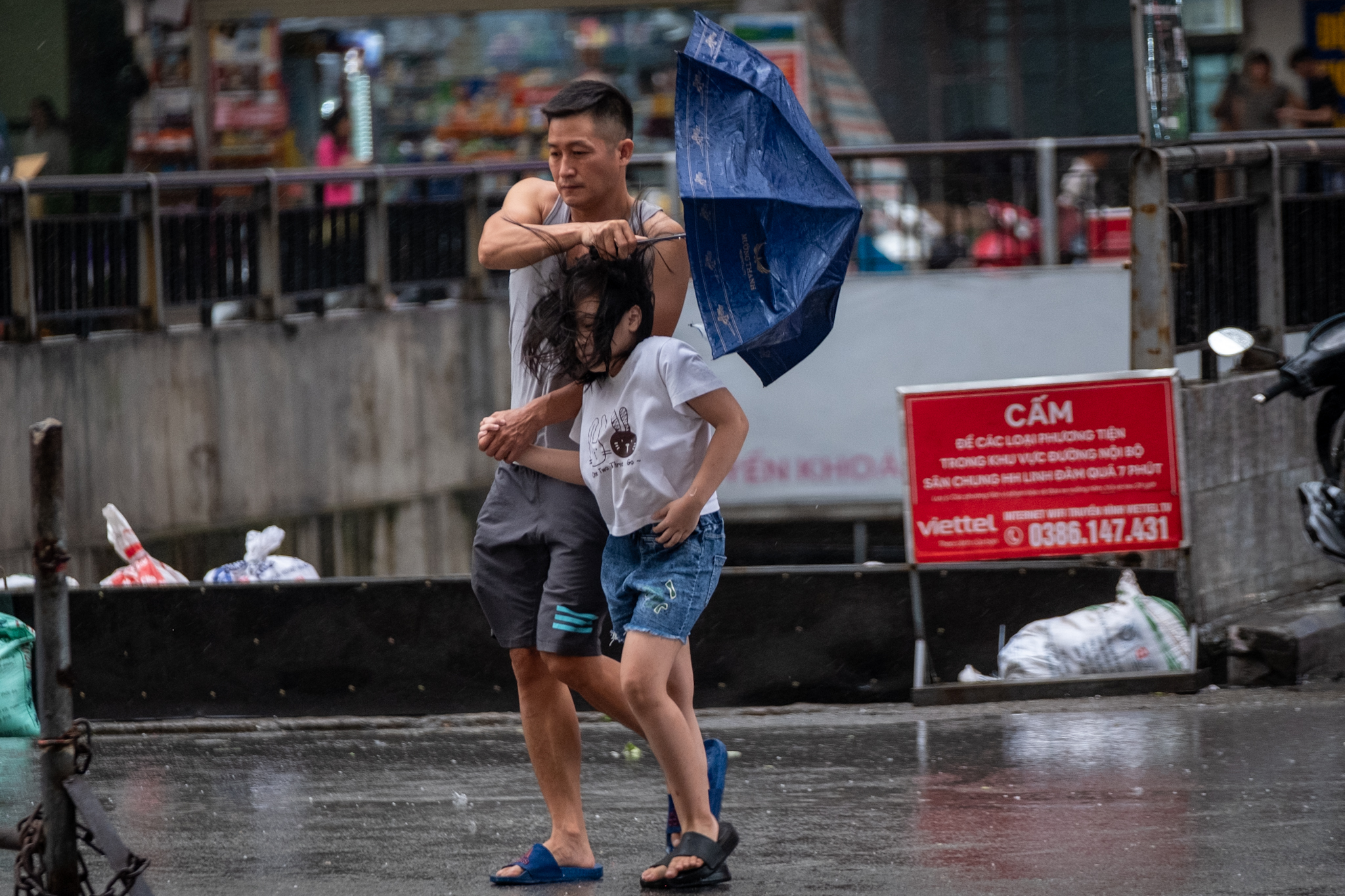 Hà Nội trước khi bão YAGI đổ bộ: Đường phố vắng vẻ, mưa gió tạt mạnh khiến người dân gồng mình chống chọi- Ảnh 11.