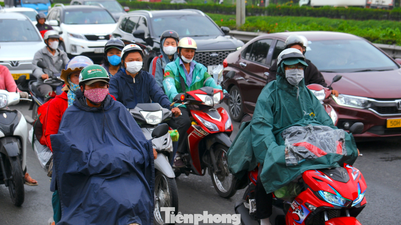 Cửa ngõ TPHCM chật kín người về quê đón Tết trong mưa trái mùa- Ảnh 1.